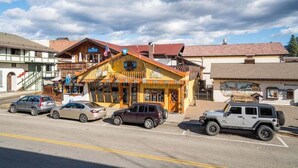 A building with a yellow facade, a staircase, and a sign that reads 'The Lodge.' - Downtown Leavenworth King Studio - Parking + Balcony (Leavenworth)