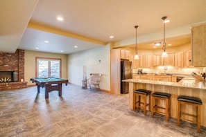 A spacious kitchen with wooden cabinets, a built-in bar area, and a pool table. - Heavenly Heights - Sweeping Territorial Views (Leavenworth)