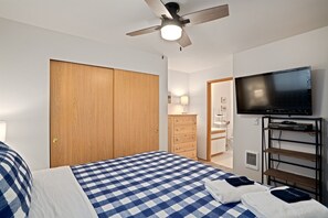 Relax in comfort with a large bed, flat-screen TV, and ample storage space.