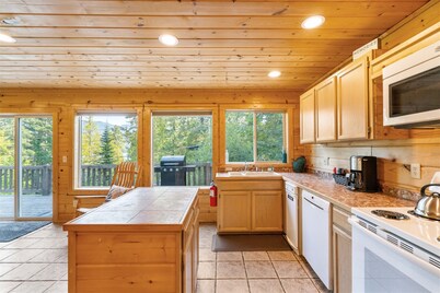 Dog-friendly hillside home with Peek a Boo Lake Views!  Great trails nearby. BBQ grill provided.