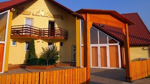 Un bâtiment jaune avec un toit rouge, un balcon et une enseigne sur laquelle on peut lire « Casa Andarasa ».