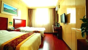 A hotel room with two beds, a desk, a television, and a painting on the wall. - Greentree Inn Shanghai Baoshan District Gongfu New Village Metro Station Express Hotel (Shanghai)
