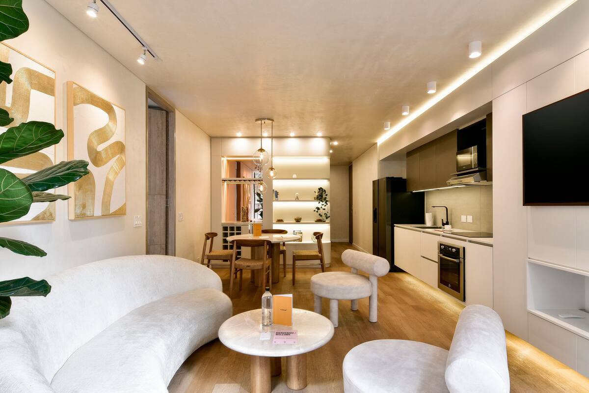A modern interior with a dining area, kitchen, and seating.