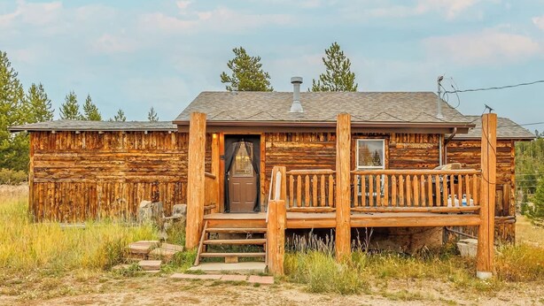 A rustic log cabin with a porch, a chimney, and a small window. - Cabin 1, Aspen Leaf Lodges, Near Grand Lake (Grand Lake)