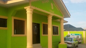 A green building with a sign reading "GOSHEN HERITAGE VILLA". - JiL Service Flat (Ibadan)