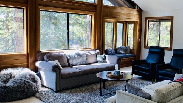 A spacious living room with a high ceiling, large windows, and a cozy seating area. - Our Lake Tahoe H💙ME<br> (Tahoe City)