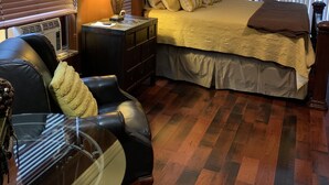 A bedroom with a bed, a desk, a chair, a lamp, and a ceiling fan. - Beautiful home and/or garage apartment, minutes from Oaklawn Park. (Hot Springs)