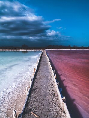 A pier extending into a body of water with a clear sky above.