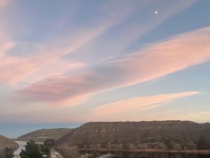 A landscape with a body of water, hills, and a clear sky with clouds. - Lake View Casa (Fort Collins)