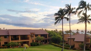 A hotel with multiple buildings, a well-maintained lawn, and palm trees. - Wailea Ekahi 10C - Just steps away from Main Pool & Beach!  - Family Managed (Kihei)