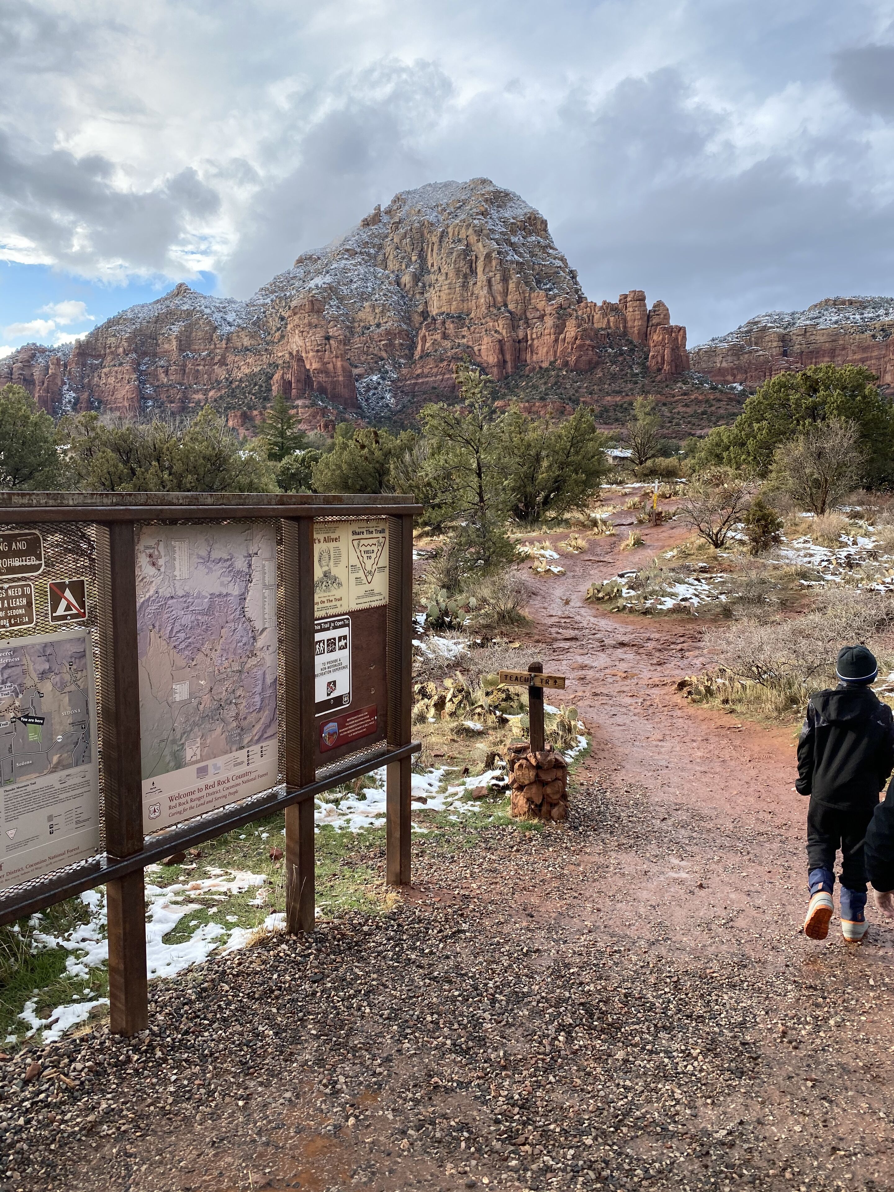 A trail sign with a map and information about Red Rock Canyon National Monument.