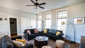 A spacious living room with two dark sofas, a coffee table, and a patterned rug. - South Main Chalet- Luxury living in BV- STR-120 (Buena Vista)