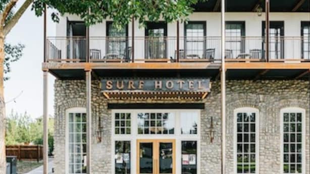 A two-story building with a stone facade and a sign reading "Surf Hotel". - South Main Chalet- Luxury living in BV- STR-120 (Buena Vista)