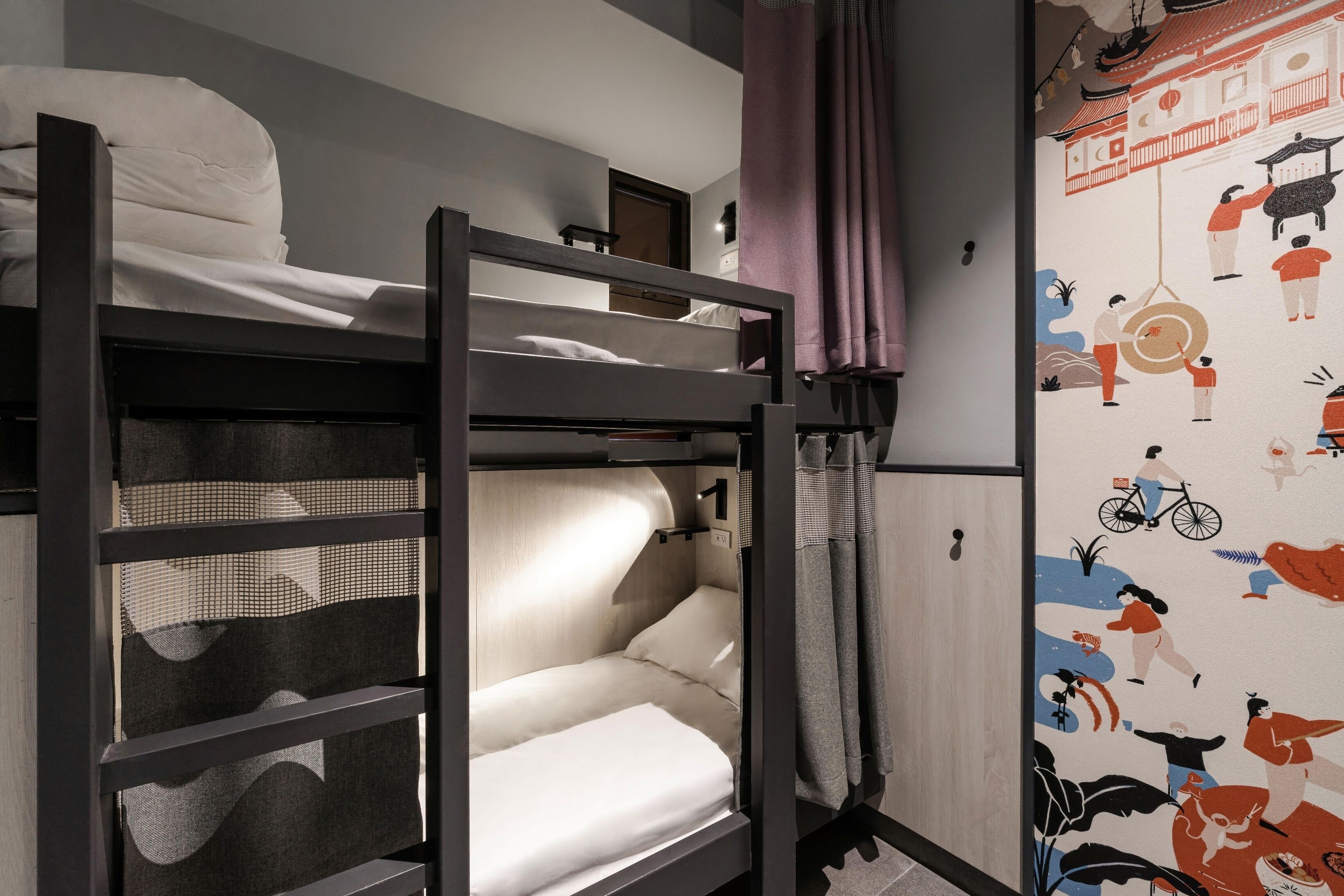 A bunk bed room with a curtain and a wall mural.
