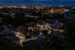 A traditional Japanese town at night with illuminated buildings and a river. - The Moment Hotel Yilan by Lakeshore (Wujie)