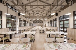 A spacious cafeteria with high ceilings, large windows, and neatly arranged tables and chairs. - The Moment Hotel Yilan by Lakeshore (Wujie)