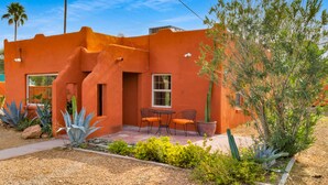 A stucco building with a patio, two chairs, and a cactus. - Midtown Territorial Home Beautifully Updated + Convenient  2 miles U of A (Tucson)
