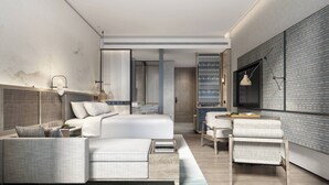 A modern bedroom with a bed, a sofa, a small table, and a chair. There is a large window with a view of the city. - Courtyard by Marriott Liuzhou Sanjiang (Liuzhou)