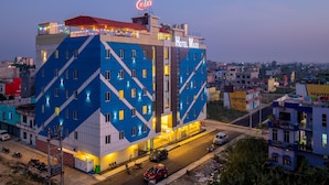 A multi-story hotel with a distinctive blue and white geometric facade, a rooftop bar, and a prominent sign. - Hotel Maxx (Kohalpur)