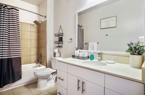 Combined shower/bathtub, hair dryer, towels, toilet paper