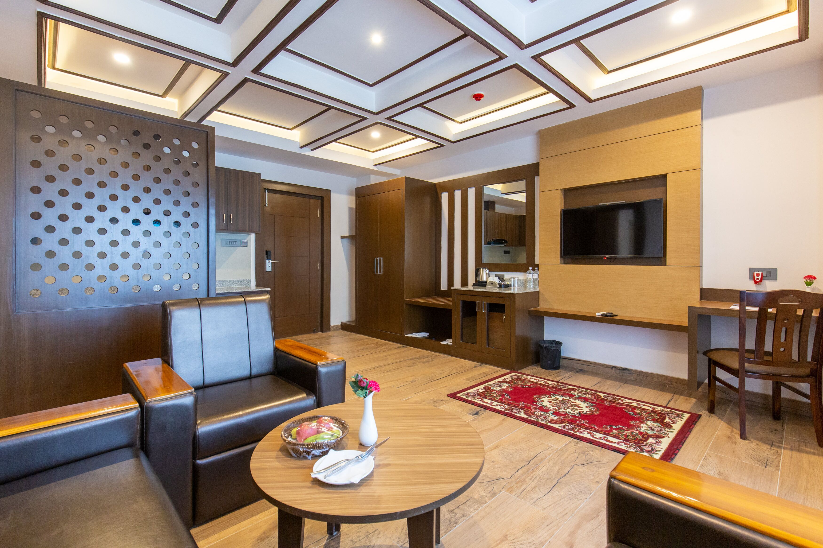 A modern living room with a sofa, a coffee table, and a TV.