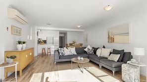 Relax in this stylish living room with a comfortable sofa, coffee table, and geometric-patterned rug.