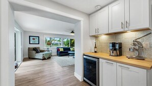 A modern kitchen with white cabinets, a coffee maker, and a dishwasher. - Beautiful Villa With First Class Amenities on Charlotte Harbor, Orlando Villa 5584 (Punta Gorda)