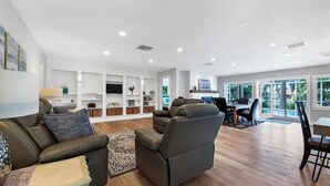 A spacious living room with a sofa, armchairs, and a dining area with a table and chairs. - Beautiful Villa With First Class Amenities on Charlotte Harbor, Orlando Villa 5584 (Punta Gorda)