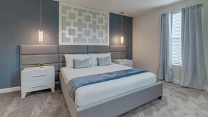 A modern bedroom with a large bed, two bedside tables, a decorative wall panel, and a window with curtains. - Modern Villa With Ocean Views 5588 (Kissimmee)