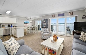 Relax in this living area with a sofa set, coffee table, and TV, and enjoy the scenic view from the balcony.