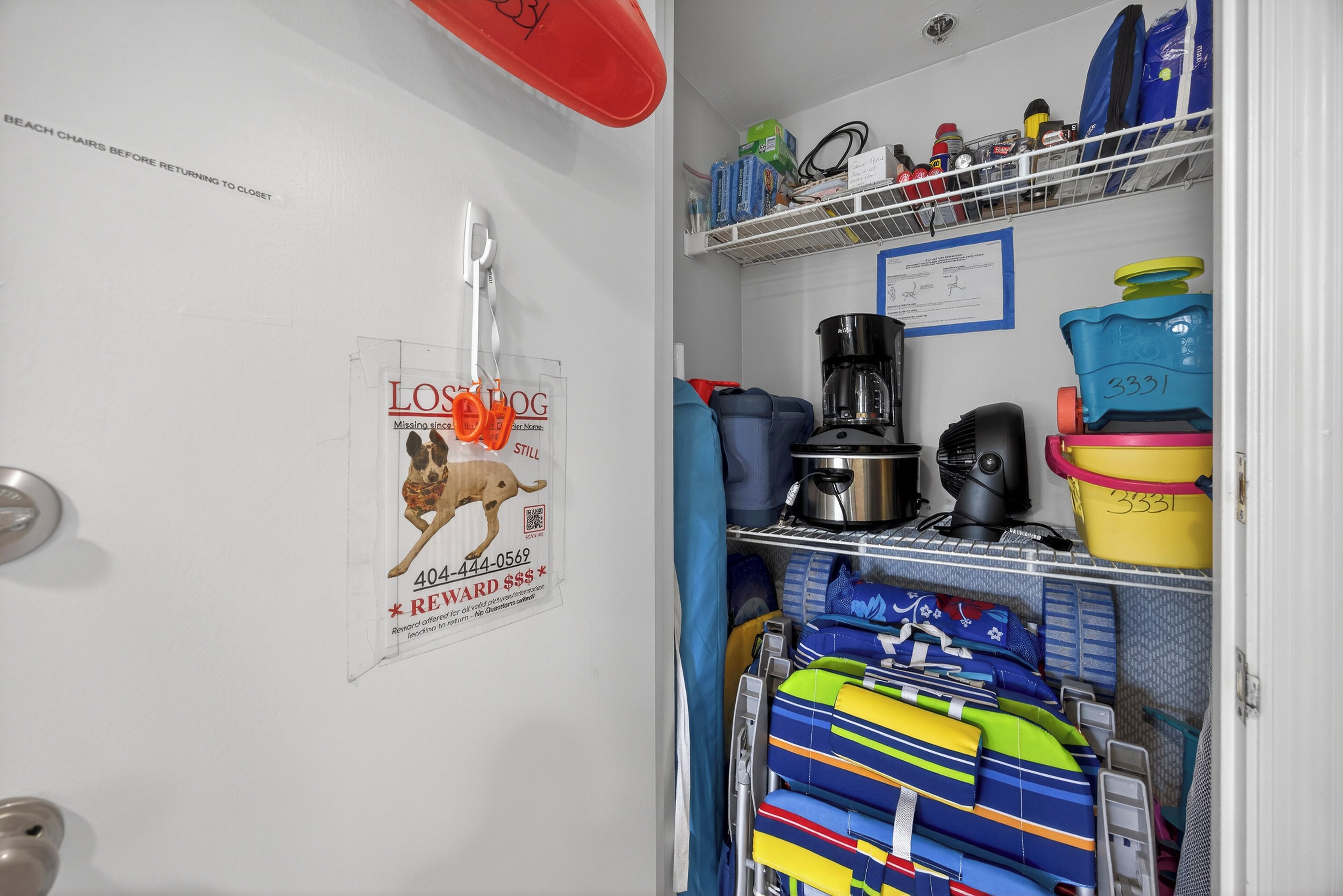 A storage area with shelves containing various items, including a coffee maker, a fan, and containers.