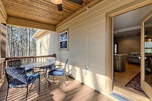 Enjoy dining al fresco on the deck, surrounded by lush trees and a glimpse of the interior kitchen.