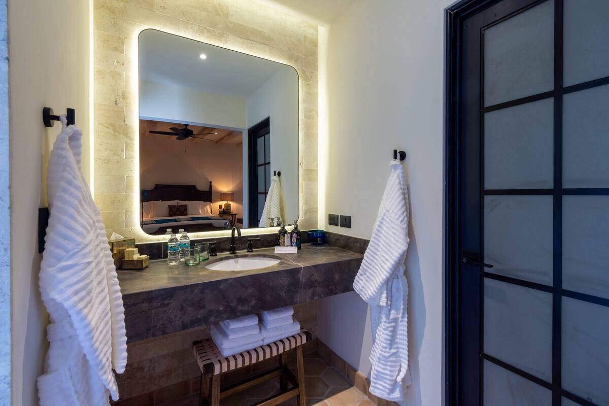 deluxe room | bathroom | designer toiletries, hair dryer, bathrobes, slippers