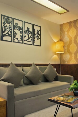 Coral Suite Room | リビング エリア | 32 インチの薄型テレビ (ケーブル放送視聴可)、テレビ