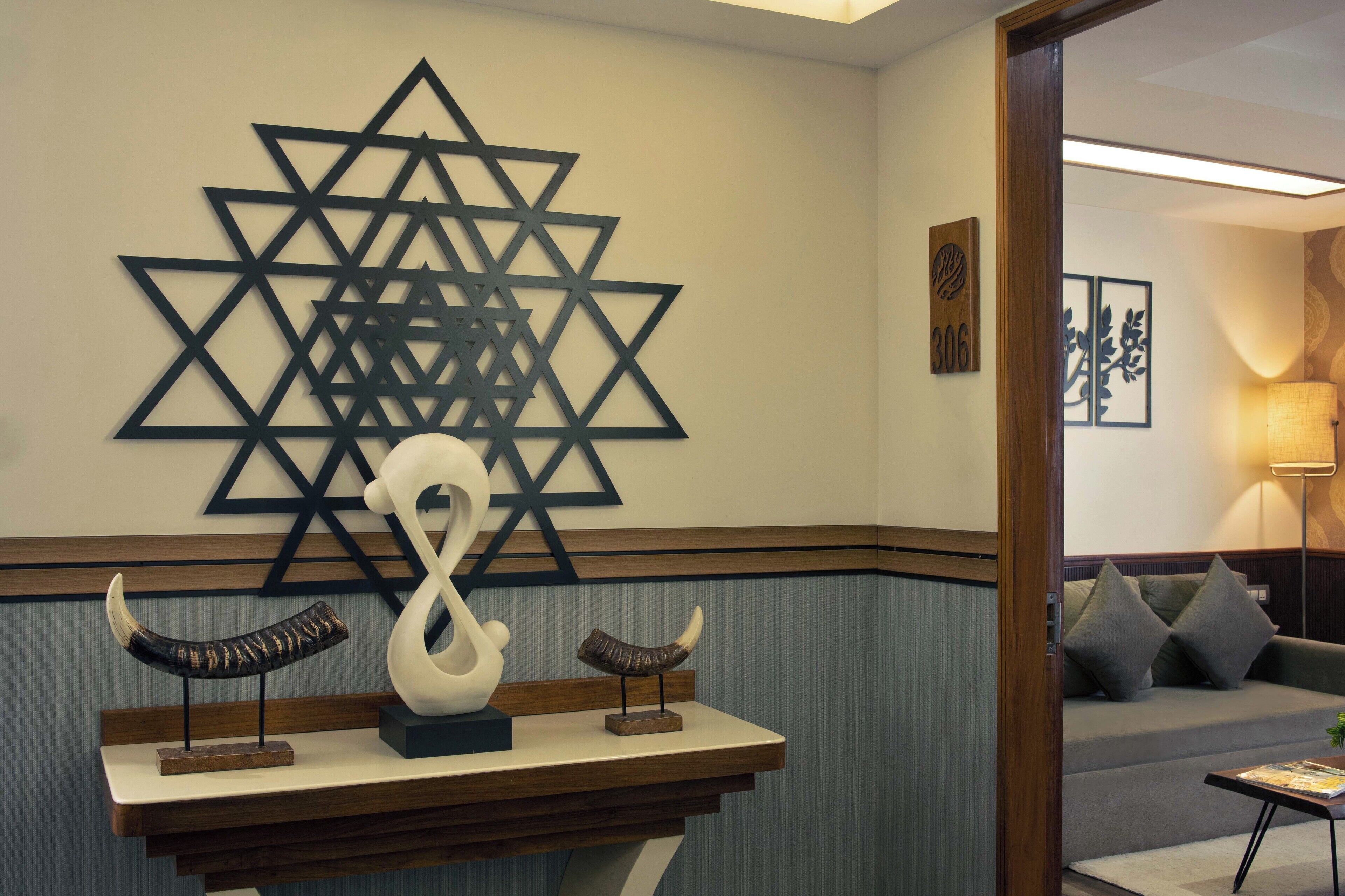 A reception area with a wall-mounted Star of David, a decorative sculpture, and a wooden counter.