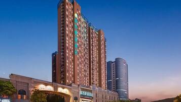 A high-rise hotel with multiple floors, a prominent entrance, and a modern design.