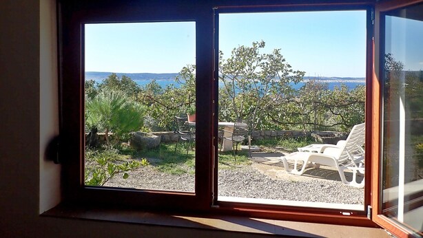 A view through a window with a clear sky and distant landscape. - Vacation home in traditional style in a very quiet location (Starigrad Paklenica)