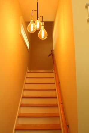 Eine Treppe mit Holzdielen und Handlauf, die nach oben führt.