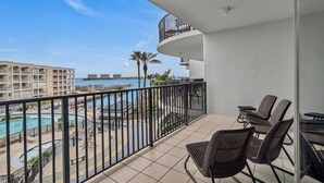 A balcony with a view of a swimming pool and a building complex. - Lighthouse on the Bay 2308-2bd/2ba-Pet Friendly, Lazy River, Boatslip, Bay Views (Orange Beach)