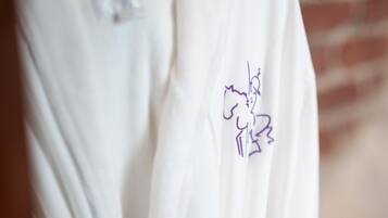 A white robe with a purple embroidered design on the front.