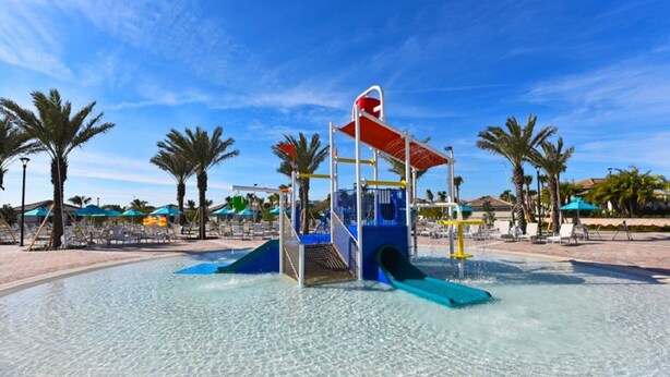 A water play area with slides and a climbing structure, surrounded by palm trees and lounge chairs. - 412 OC  - 5BR Home Bliss: Private Pool - Sleeps 14 (Four Corners)