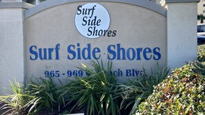 A sign for Surf Side Shores with the address 965-969 8th Ave.