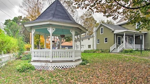 A gazebo with a white railing and a conical roof, surrounded by a lawn with fallen leaves. - Idyllic Wallingford Retreat - Near Skiing & Hiking (Wallingford)