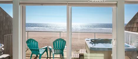 A beach view from a room with a large window, a clock, and a sign that reads "beach".