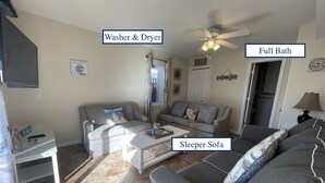 A living room with a washer & dryer, a full bath, and a sleeper sofa. - Jersey Shore - Summer 2025 - Lavallette - Sleeps up to 8! (Lavallette)