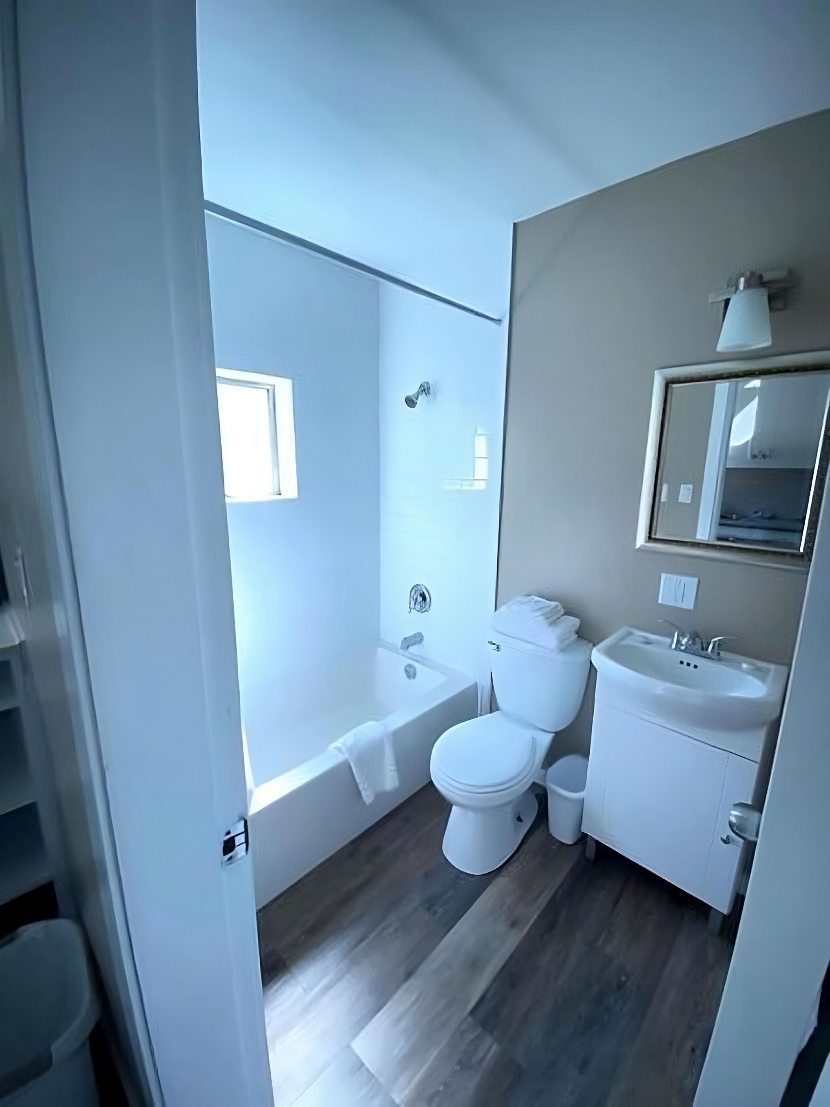 A bathroom with a bathtub, toilet, and sink.