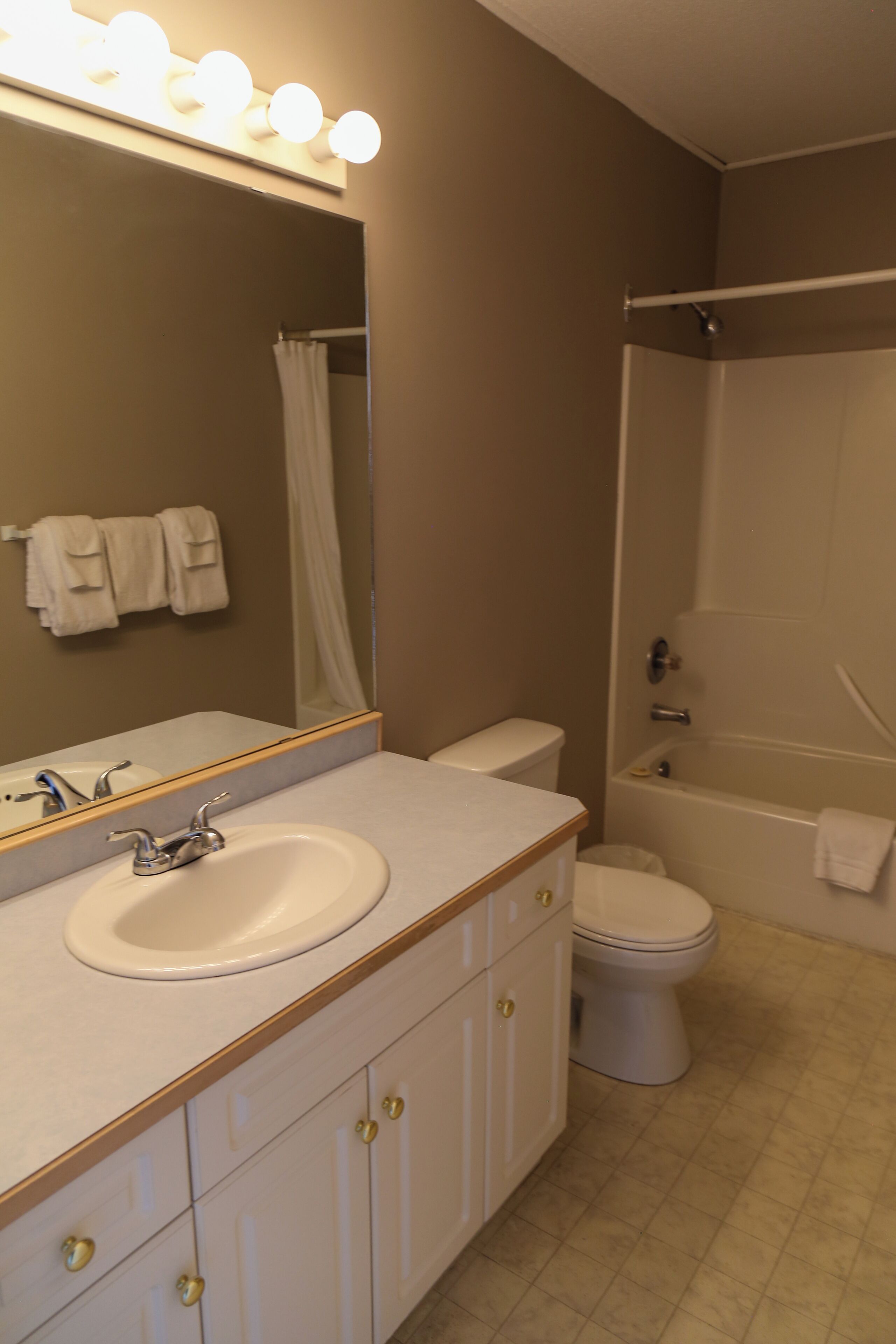 A bathroom with a sink, toilet, and bathtub.