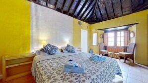 A hotel room with a bed, two bedside tables, a chair, a window, and a door. - Holidays Tenerife breakfast inclusive wifi pool fr (La Laguna)
