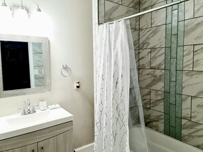 Combined shower/tub, hair dryer, towels, soap