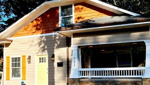 A two-story house with a stone foundation, a front porch, and a garage door. - 3BR/4BA w/ Great place for having fun in the middle of the city!!!! (Atlanta)